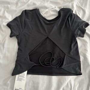 Lululemon open tie back short sleeve Brand New with tags size 8 in black.